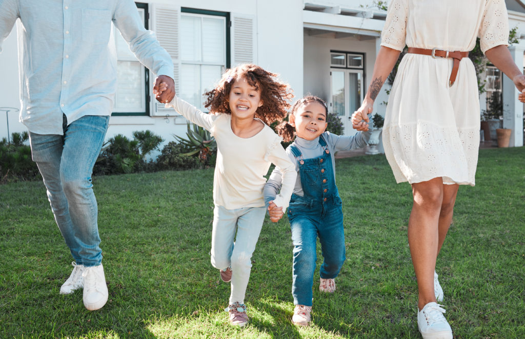Family holding hands of smiling kids