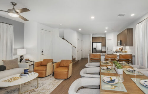 beautiful kithcen and dining room at Arista Mckinney townhome with dining room table set and kitchen appliances and cabinets as well as seating.